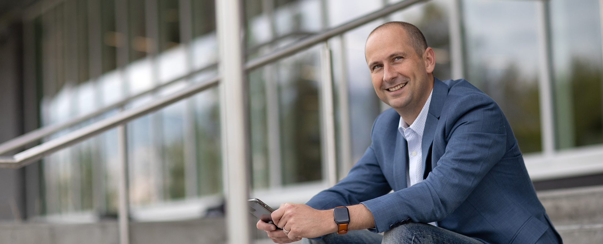 The Associate Vice-President, Students Dale Mullings sitting on the steps in front of the Commons building