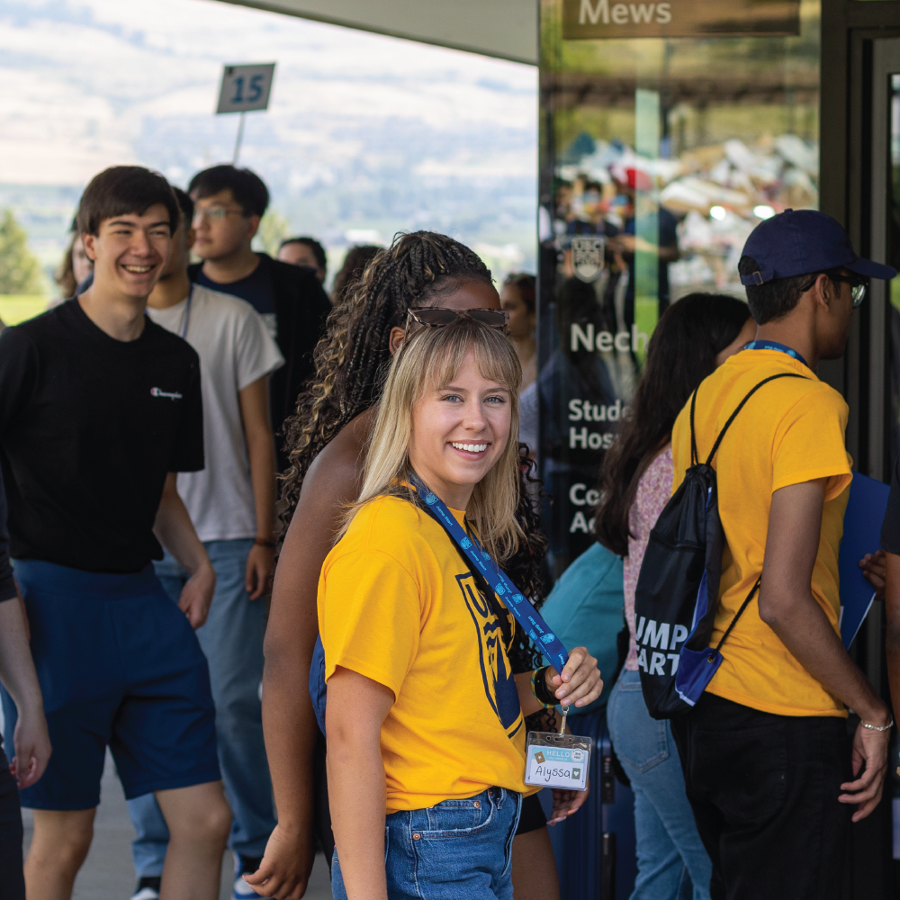 A group of students at orientation, looking at the camera